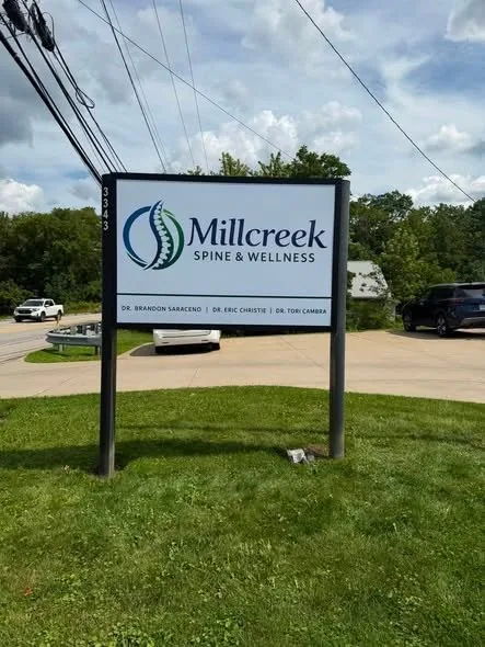 The Millcreek Spine & Wellness roadside sign at 3343 West 38th Street